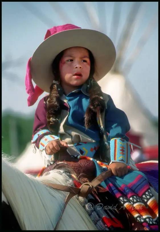 Native American boy on horseback.