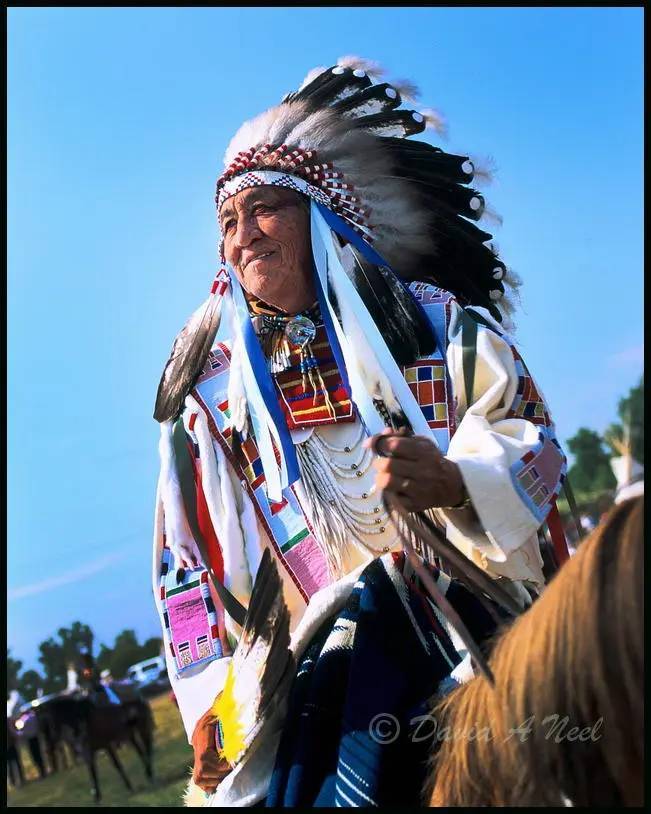 Crow Indian chief on horseback.